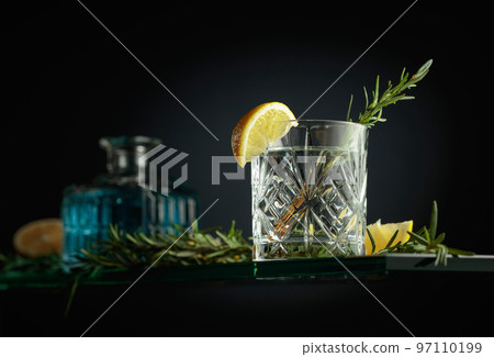 Gin tonic cocktail in a crystal glass. Gin tonic cocktail in a crystal glass. 97110199
