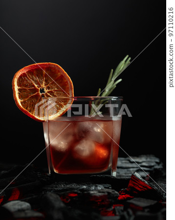 Old-fashioned cocktail with whiskey, ice, orange, and rosemary. Old-fashioned cocktail with whiskey, ice, orange, and rosemary. 97110216