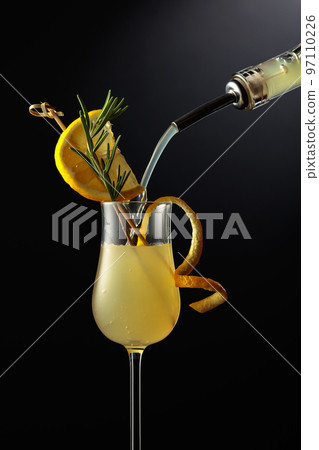 Limoncello is poured into a glass. 97110226
