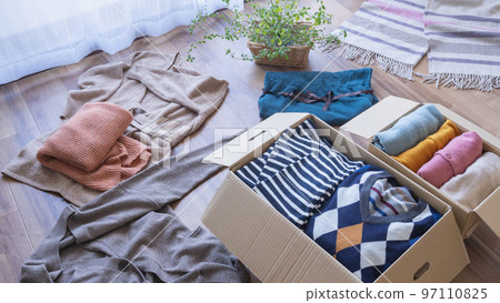 Clothes in cardboard | Changing, discarding, and recycling image 97110825