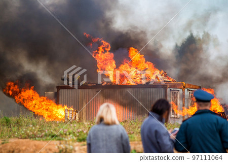 A building in fire. Training fire service to extinguish a fire, civil defense exercises A building in fire. Training fire service to extinguish a fire, civil defense exercises 97111064