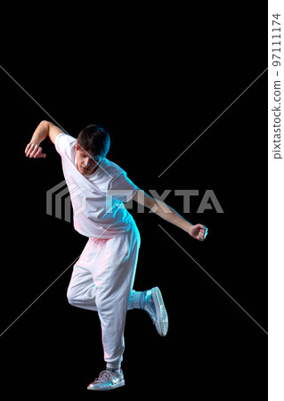 young man in black t-shirt and jeans dancing 97111174