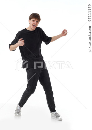 young man in black t-shirt and jeans dancing 97111179