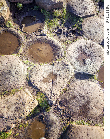 One of the 40000 interlocking basalt columns at the Giant's Causeway has the shape of a heart - Bushmills in Northern Ireland, United Kingdom One of the 40000 interlocking basalt columns at the Giant's Causeway has the shape of a heart - Bushmills in Northern Ireland, United Kingdom 97111196