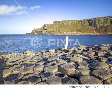 A few of the 40000 interlocking basalt columns at the Giant's Causeway by Bushmills in Northern Ireland, United Kingdom A few of the 40000 interlocking basalt columns at the Giant's Causeway by Bushmills in Northern Ireland, United Kingdom 97111197