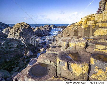 A few of the 40000 interlocking basalt columns at the Giant's Causeway by Bushmills in Northern Ireland, United Kingdom A few of the 40000 interlocking basalt columns at the Giant's Causeway by Bushmills in Northern Ireland, United Kingdom 97111201