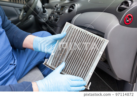 Replacing dirty cabin pollen air filter for a car Replacing dirty cabin pollen air filter for a car 97114872