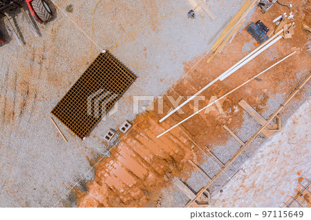Delivering reinforced concrete steel rods bars to foundation using forklift on construction site Delivering reinforced concrete steel rods bars to foundation using forklift on construction site 97115649