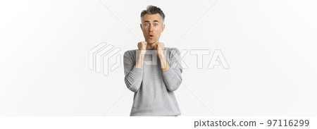Image of scared middle-aged man with gray hair, jumping frightened and looking alarmed at something scary, standing over white background Image of scared middle-aged man with gray hair, jumping frightened and looking alarmed at something scary, standing over white background 97116299