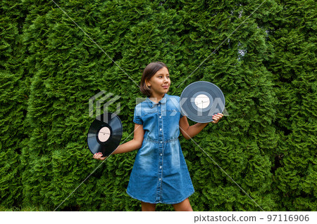 child girl holds vinyl records 97116906