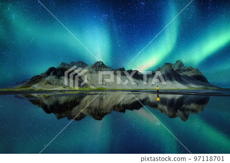 Landscape of Aurora borealis glowing over Vestrahorn mountain in viking village on Stokknes Peninsula at Iceland Landscape of Aurora borealis glowing over Vestrahorn mountain in viking village on Stokknes Peninsula at Iceland 97118701