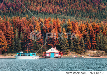 Cottage and ferry by the lake in pine forest on autumn at Jasper national park Cottage and ferry by the lake in pine forest on autumn at Jasper national park 97118735