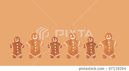 Group of christmas gingerbread men on brown background 97119264