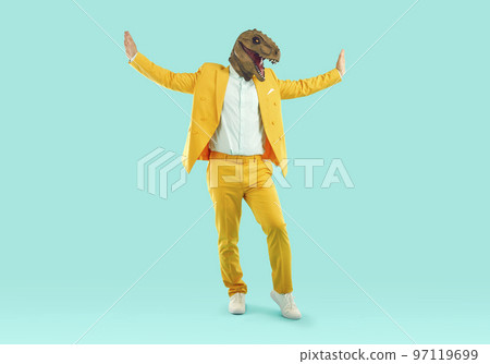 Portrait of cheerful stylish man in trendy rubber dinosaur mask dancing and fooling around. 97119699