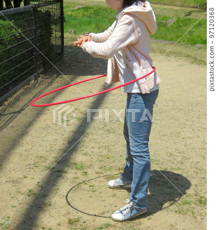 Woman doing hula hoop 97120368