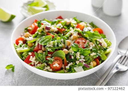 Tabbouleh salad. Tabouli salad with fresh parsley, onions, tomatoes, bulgur and chickpea. Healthy vegetarian food, mediterranean diet 97122462