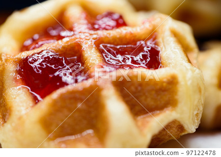 Close up fresh waffles with above strawberry jam Close up fresh waffles with above strawberry jam 97122478
