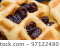 Close up fresh waffles with above dried raisins 97122480