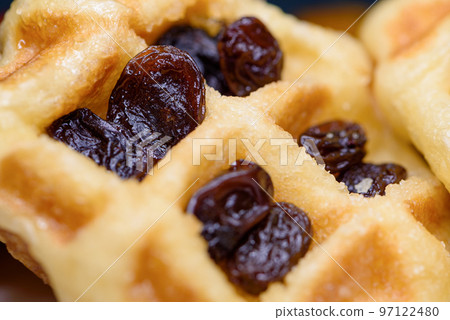 Close up fresh waffles with above dried raisins Close up fresh waffles with above dried raisins 97122480