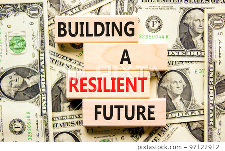 Building a resilient future symbol. Concept word Building a resilient future on wooden blocks. Beautiful background from dollar bills. Business and building a resilient future concept. Copy space. 97122912