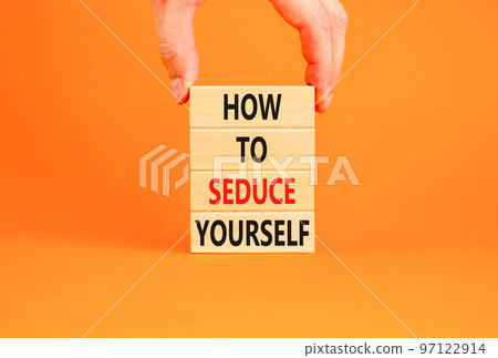How to seduce yourself symbol. Concept word How to seduce yourself on wooden blocks. Businessman hand. Beautiful orange table orange background. Business and how to seduce yourself concept. Copy space How to seduce yourself symbol. Concept word How to seduce yourself on wooden blocks. Businessman hand. Beautiful orange table orange background. Business and how to seduce yourself concept. Copy space 97122914