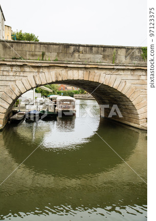 A historic stone arch bridge over the River Thames in Oxford A historic stone arch bridge over the River Thames in Oxford 97123375