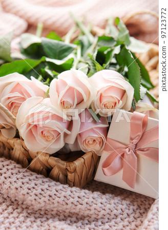 Tray with bouquet of beautiful pink roses and gift box on bed. Tray with bouquet of beautiful pink roses and gift box on bed. 97123772