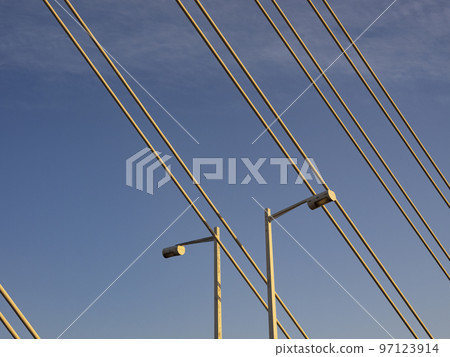 Bridge wires and lamp posts in the evening sun Bridge wires and lamp posts in the evening sun 97123914