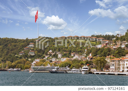 Green mountains of the European side of Bosphorus strait, with docked boats, houses and dense trees in a summer day Green mountains of the European side of Bosphorus strait, with docked boats, houses and dense trees in a summer day 97124161