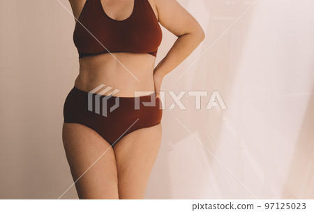 Confident young woman feeling positive and comfortable in her body. 97125023