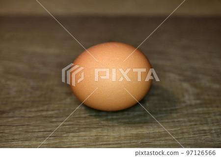 The chicken egg lies on the floor. 97126566