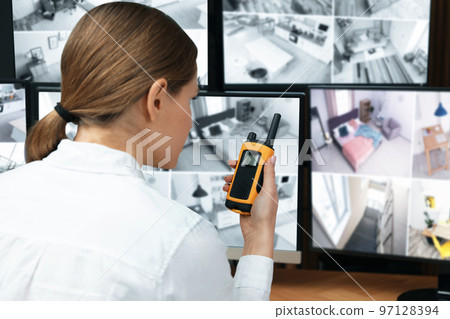 Security guard using portable transmitter at workplace Security guard using portable transmitter at workplace 97128394