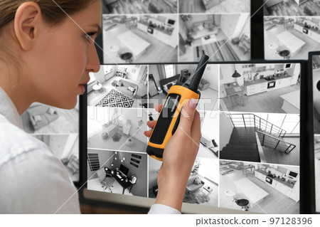 Security guard using portable transmitter at workplace, closeup Security guard using portable transmitter at workplace, closeup 97128396