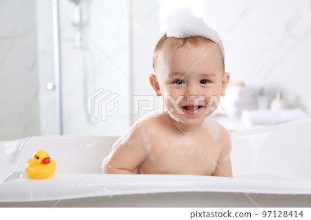 Cute little baby in bathtub at home Cute little baby in bathtub at home 97128414
