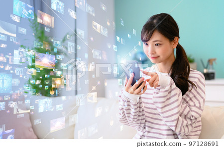 Woman operating a smartphone Woman operating a smartphone 97128691