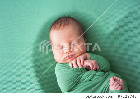 Newborn baby in green diaper is sleeping. Newborn baby in green diaper is sleeping. 97128745