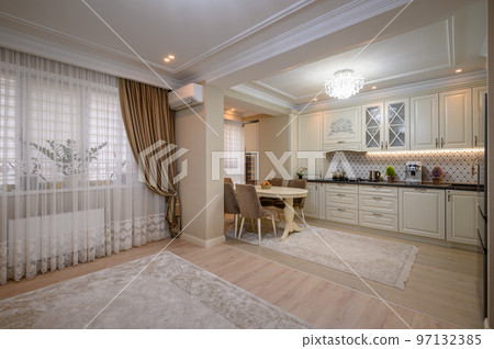 Classic beige kitchen with counter space and a variety of appliances Classic beige kitchen with counter space and a variety of appliances 97132385