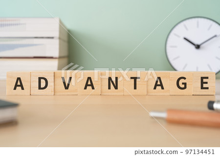 A desk with a block written ADVANTAGE A desk with a block written ADVANTAGE 97134451