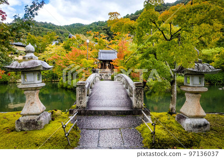 Beautiful stone bridge in Eikando Temple pond at fall 97136037