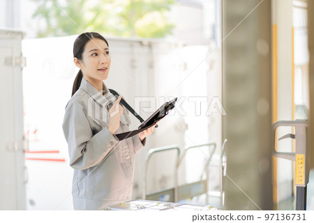 Young female worker working in distribution warehouse 97136731