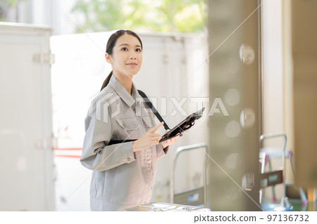 Young female worker working in distribution warehouse 97136732