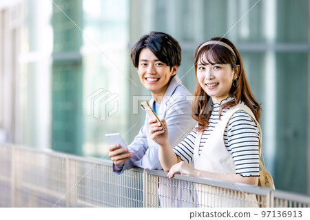 Men and women who operate smartphones at school 97136913