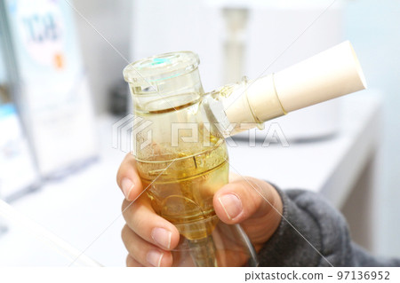 Child's hand holding nasal nebulizer (Korea) 97136952