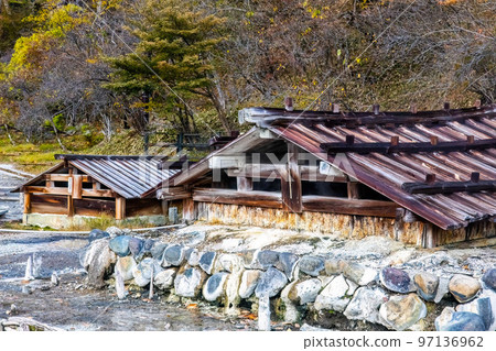 Old wooden onsen bath houses spa buildings in Nikko Japan 97136962
