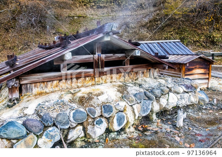 Old wooden onsen bath houses spa buildings in Nikko Japan 97136964