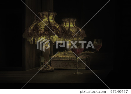 The reflection of the glass of wine in the mirror and in the dim light of Vintage night lamp on the table. 97140457