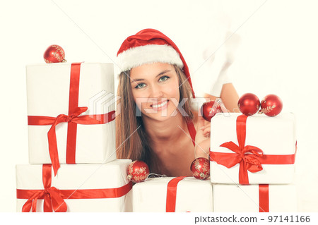beautiful young woman in Christmas suit with a stack of Christmas gifts. 97141166