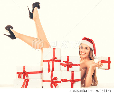 beautiful young woman in Christmas costume lying near the pile of Christmas gifts. 97141173