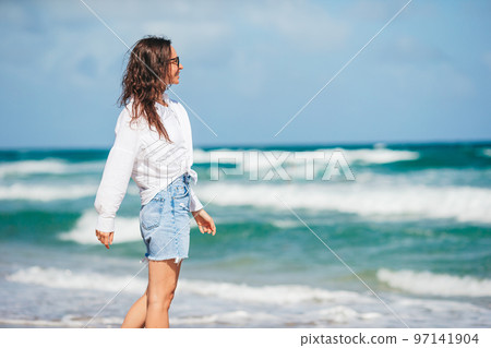 Young happy woman on the beach 97141904
