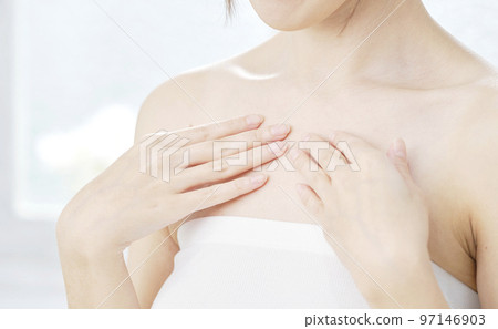 A woman taking care of her chest No face A woman taking care of her chest No face 97146903
